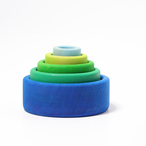 grimm's stacking wood bowls nested together ocean blue from largest to smallest, dark blue, turquoise blue, green, yellowish green, light blue