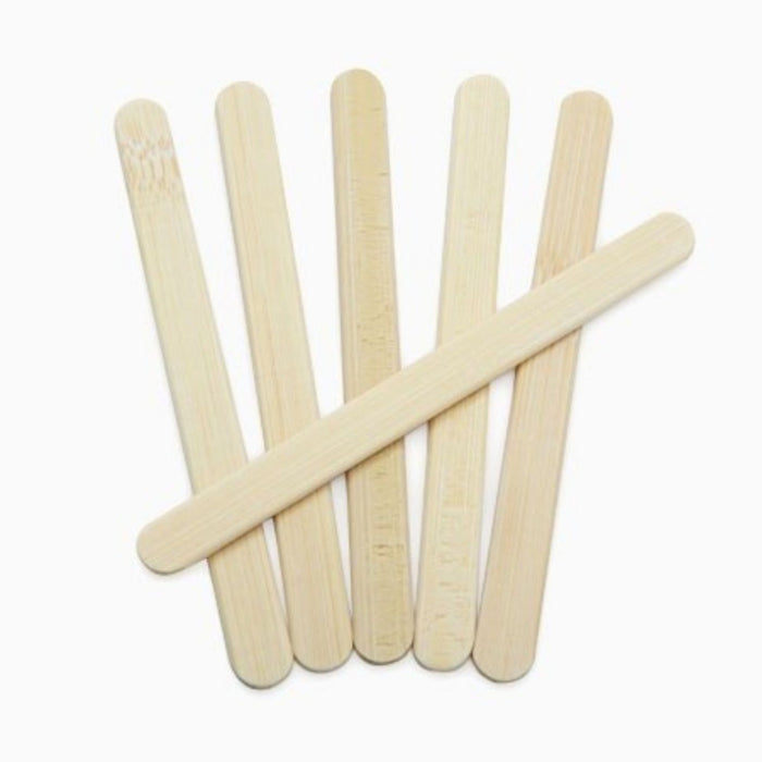6 reuseable bamboo popsicle sticks laid on white background