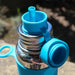 blue pura sport straw lid on a bottle outside